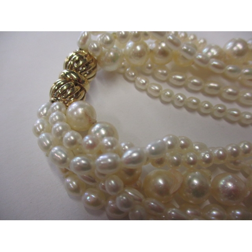 223 - A six strand baroque pearl necklace with 9ct gold clasp, approx. linear length 38cm, in good useable... 