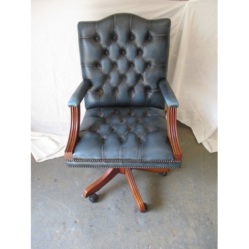 322 - A contemporary  office swivel arm chair, in deep buttoned upholstery, in pre-owned useable condition