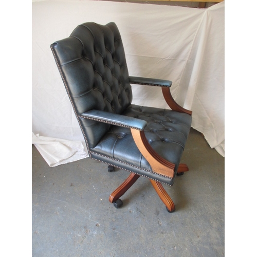 322 - A contemporary  office swivel arm chair, in deep buttoned upholstery, in pre-owned useable condition