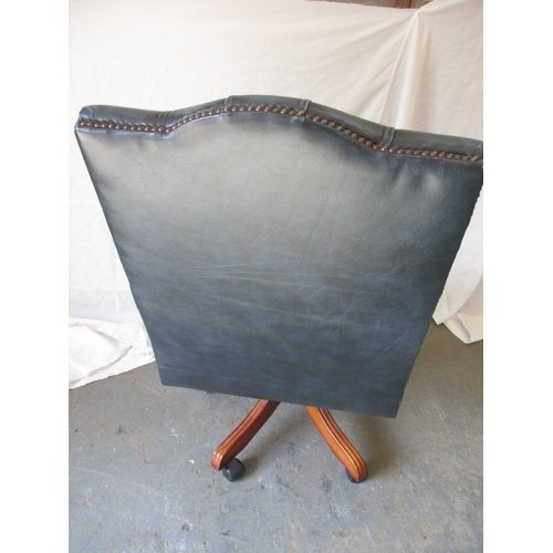 322 - A contemporary  office swivel arm chair, in deep buttoned upholstery, in pre-owned useable condition