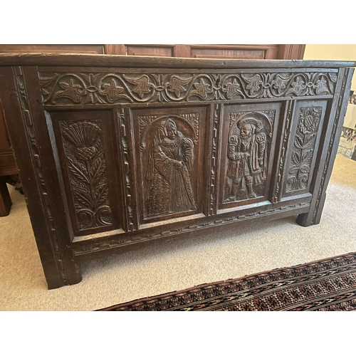 318 - An antique oak coffer, the carved front panel with Scottish Thistle and an English rose either side ... 