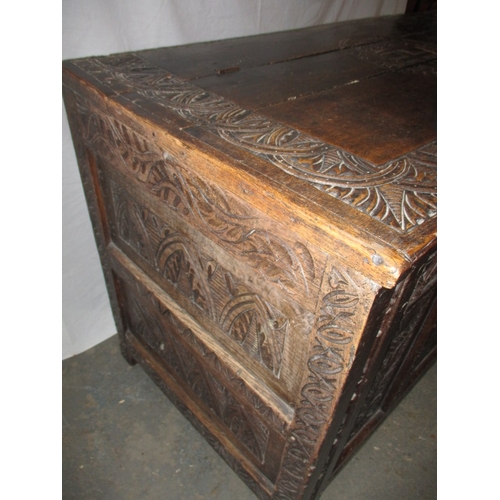 318 - An antique oak coffer, the carved front panel with Scottish Thistle and an English rose either side ... 