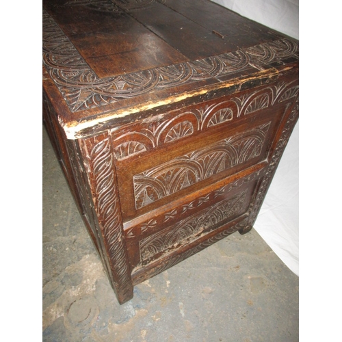 318 - An antique oak coffer, the carved front panel with Scottish Thistle and an English rose either side ... 