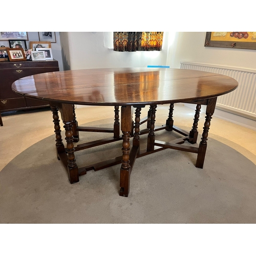 316 - A large antique oak drop leaf dining table, approx. length 197cm approx. width with leaves up 155cm,... 