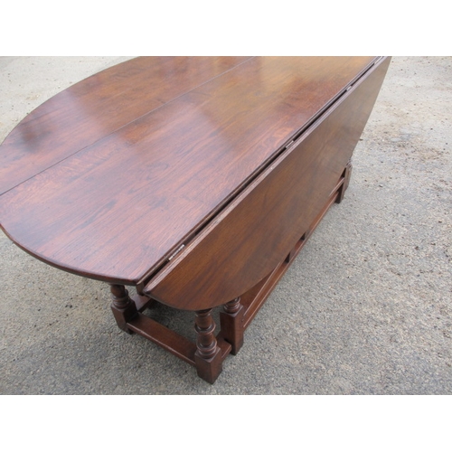 316 - A large antique oak drop leaf dining table, approx. length 197cm approx. width with leaves up 155cm,... 