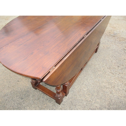 316 - A large antique oak drop leaf dining table, approx. length 197cm approx. width with leaves up 155cm,... 