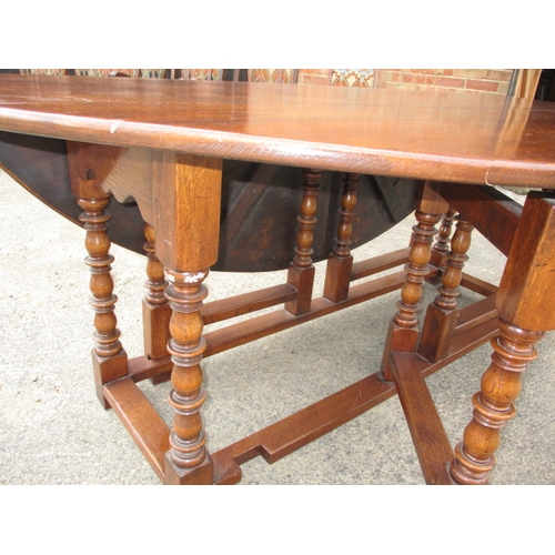 316 - A large antique oak drop leaf dining table, approx. length 197cm approx. width with leaves up 155cm,... 