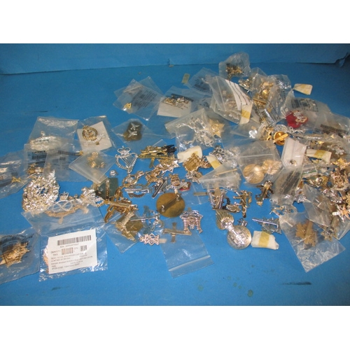 11 - A large quantity of British military stay-bright badges, some in original packaging