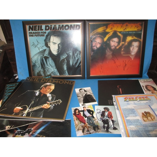 26 - A parcel of music related ephemera to include hand signed autographs from The Bee Gees, Neil Diamond... 