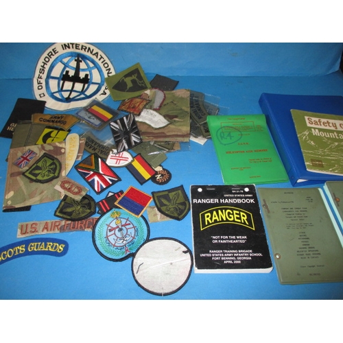 35 - A parcel of military badges and booklets, all in used condition