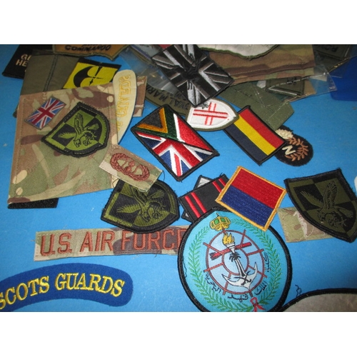 35 - A parcel of military badges and booklets, all in used condition