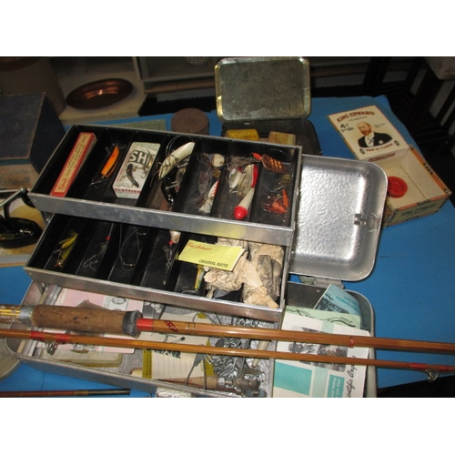 63 - A quantity of vintage fishing tackle, to include boxed reels and cane rods and a brass bait box, all... 