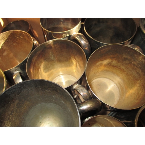 82 - A large quantity of pewter and plated tankards, some with military and railway dedications, all in u... 