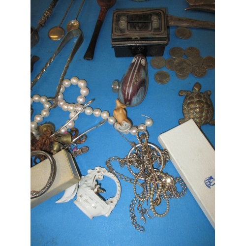 105 - A parcel of interesting collectables, to include some white metal items and a tin plate clockwork mo... 