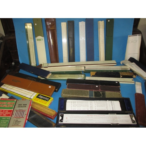 129 - A large collection of vintage slide rules, and a ‘Magic Brain Calculator, all in pre-owned condition