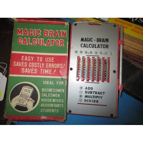 129 - A large collection of vintage slide rules, and a ‘Magic Brain Calculator, all in pre-owned condition