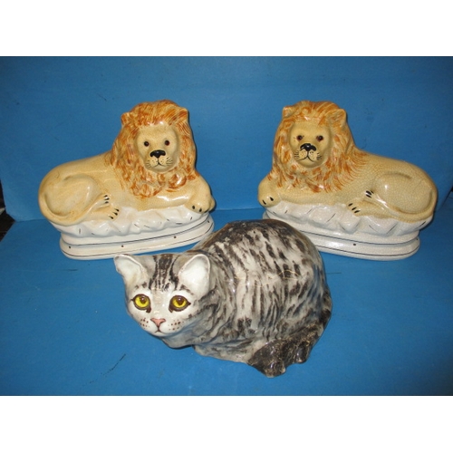 144 - A vintage Winstanley cat and 2 Staffordshire type lions, one lion with damage