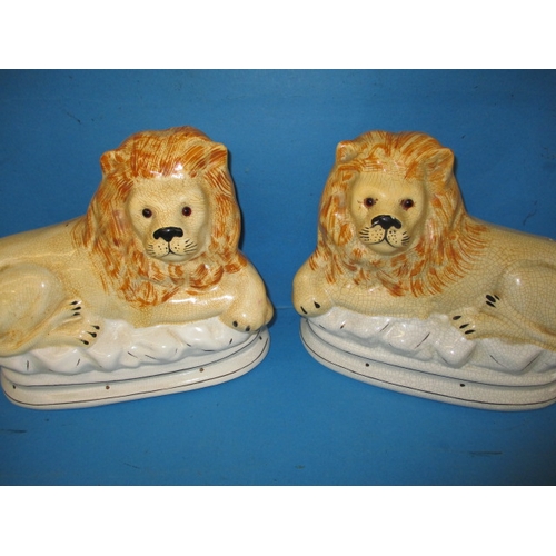 144 - A vintage Winstanley cat and 2 Staffordshire type lions, one lion with damage