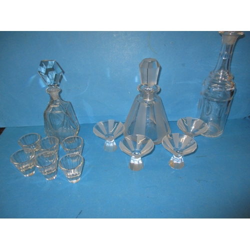 152 - Two vintage lead crystal decanters with matching glasses and another example, in pre-owned condition... 