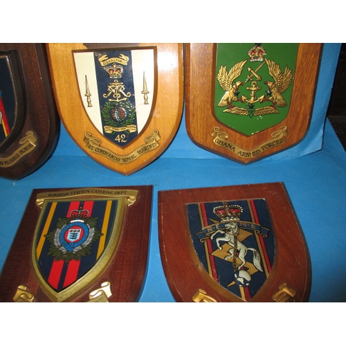 163 - A parcel of vintage military related items, to include regimental shields and badges, various ages, ... 