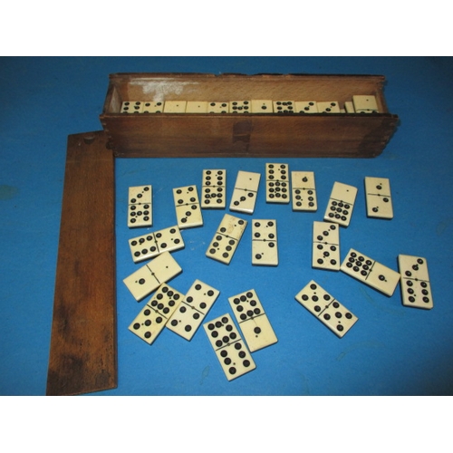 167 - A vintage set of double 9s dominos, a complete set constructed of bone and ebony, housed in period p... 