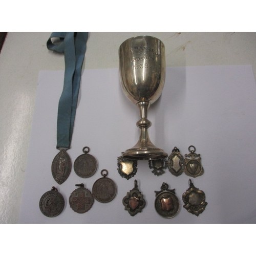 194 - A parcel of early 20th century medals and a silver trophy cup, Approx gross silver weight 118.5g, al... 