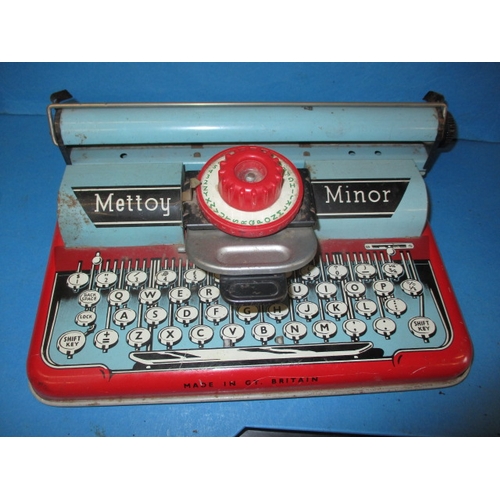 202 - A child’s Mettoy tin-plate typewriter, a child’s toy shop till  and a die-cast model car, all in use... 