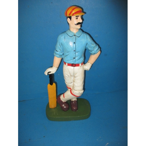 215 - A cast iron door stop in the form of a vintage cricketer, approx. height 33cm