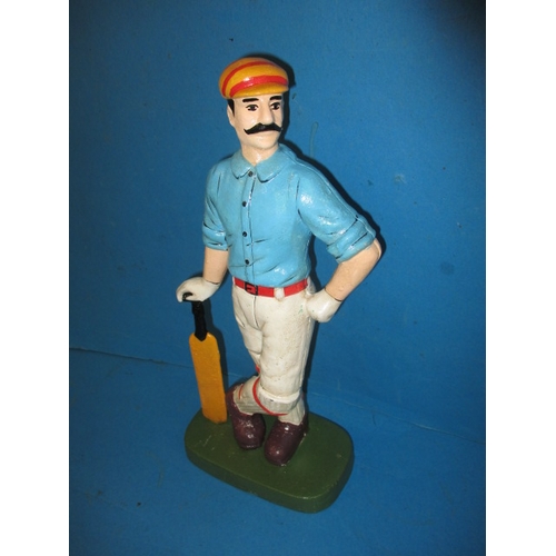 215 - A cast iron door stop in the form of a vintage cricketer, approx. height 33cm