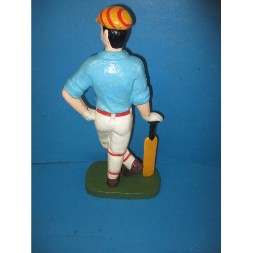 215 - A cast iron door stop in the form of a vintage cricketer, approx. height 33cm