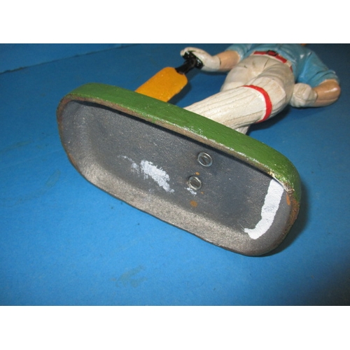 215 - A cast iron door stop in the form of a vintage cricketer, approx. height 33cm