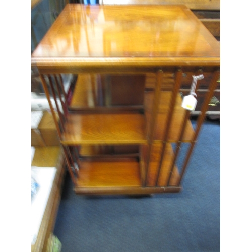 224 - A mahogany revolving book case, age related marks, floor standing on castors, approx. height 85cm