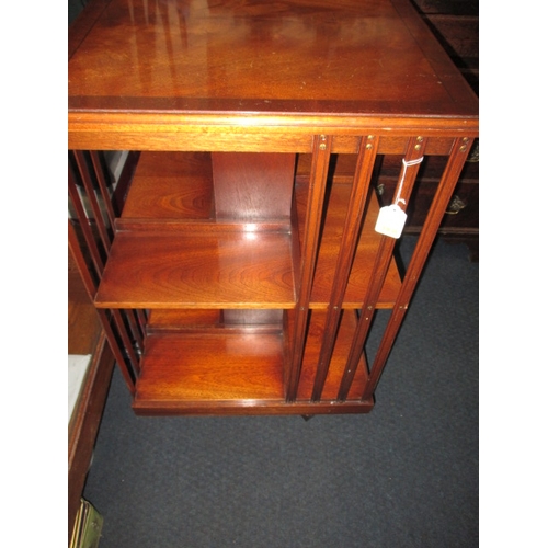 224 - A mahogany revolving book case, age related marks, floor standing on castors, approx. height 85cm