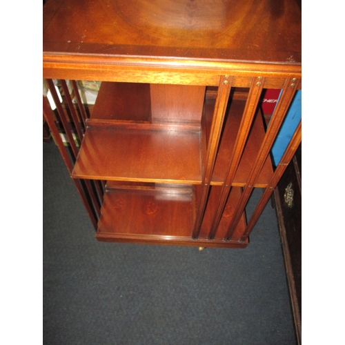 224 - A mahogany revolving book case, age related marks, floor standing on castors, approx. height 85cm