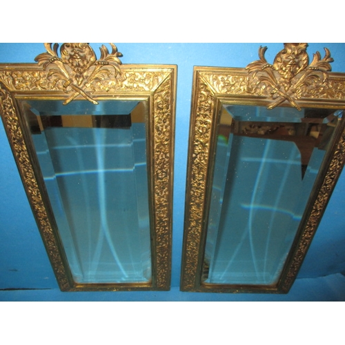 242 - A pair of early 20th century gilt brass pier mirrors, with bevelled glass panels, approx. size 45x23... 