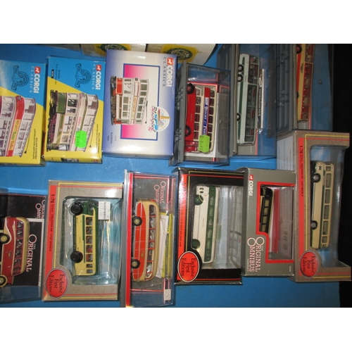 262 - A quantity of die-cast model busses and trams, most boxed and unused