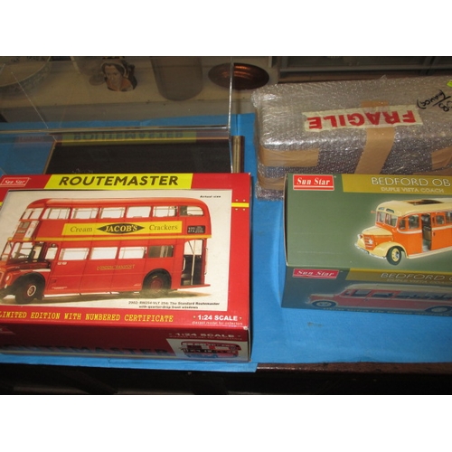 263 - Two large 1/24 scale model busses, boxed and unused and each with a Perspex display case, the Routem... 