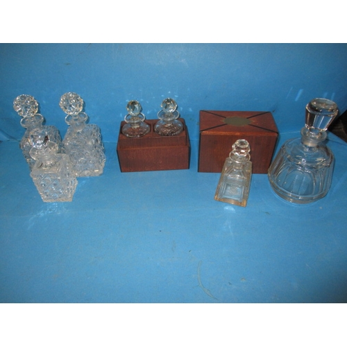 272 - A parcel of small decanters, to include a boxed pair for perfume, the mallet shape has a small chip ... 