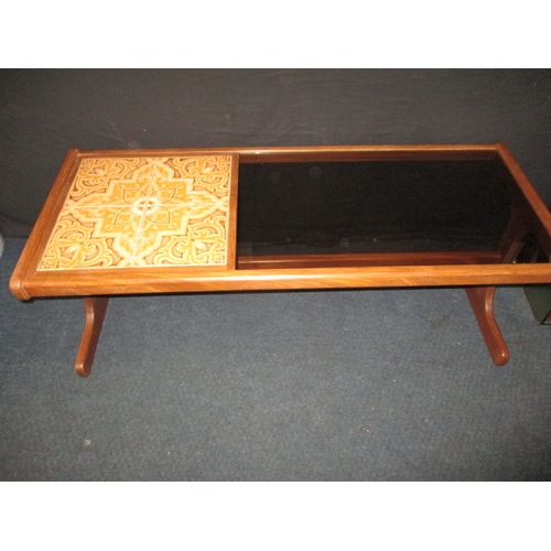 285 - A 1970s teak g-plan coffee table with tiled and smoked glazed top, approx. size: L 121cm W 50cm H 45... 