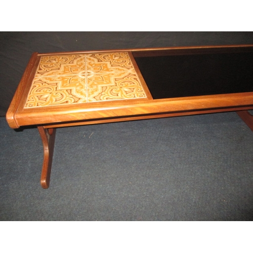 285 - A 1970s teak g-plan coffee table with tiled and smoked glazed top, approx. size: L 121cm W 50cm H 45... 