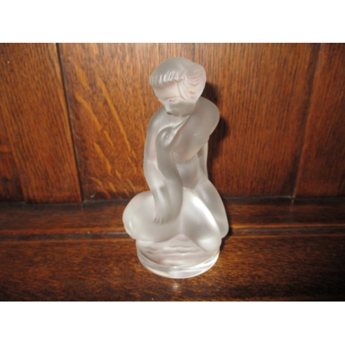 309 - A Lalique glass figurine of a woman holding a goose, signed to foot rim,  approx. height 11.5cm, no ... 