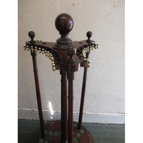 324 - A Victorian mahogany snooker cue stand, a floor standing revolving example, and a large quantity of ... 