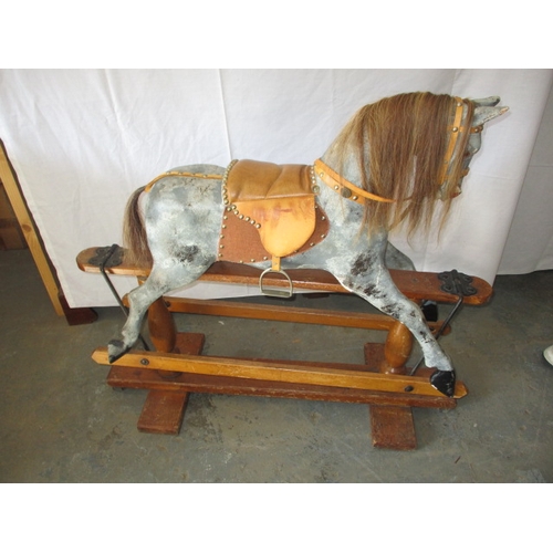 322 - A vintage hand carved rocking horse on pine safety rocker. Approximate length 107cm. In useable cond... 