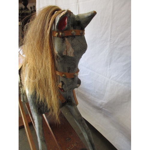 322 - A vintage hand carved rocking horse on pine safety rocker. Approximate length 107cm. In useable cond... 