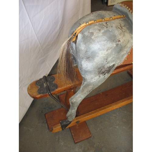 322 - A vintage hand carved rocking horse on pine safety rocker. Approximate length 107cm. In useable cond... 