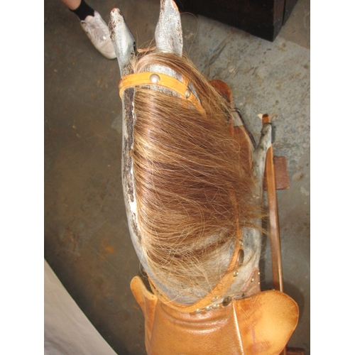 322 - A vintage hand carved rocking horse on pine safety rocker. Approximate length 107cm. In useable cond... 