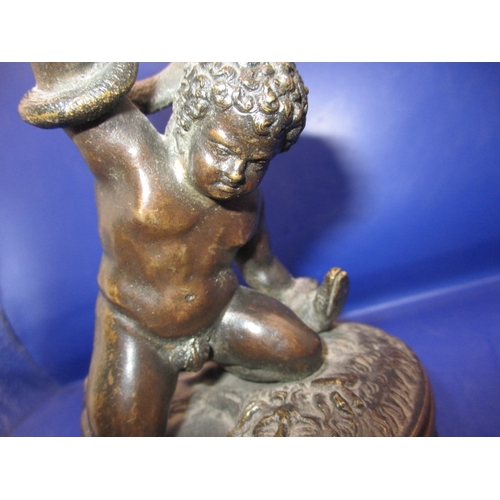 256 - An early 20th century two piece bronze sculpture of a man wrestling 2 snakes and sitting on a lion, ... 