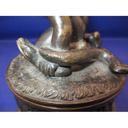 256 - An early 20th century two piece bronze sculpture of a man wrestling 2 snakes and sitting on a lion, ... 