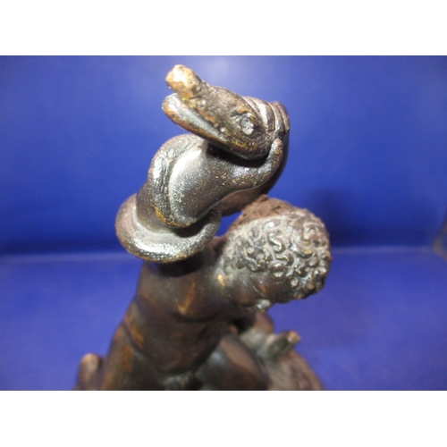 256 - An early 20th century two piece bronze sculpture of a man wrestling 2 snakes and sitting on a lion, ... 