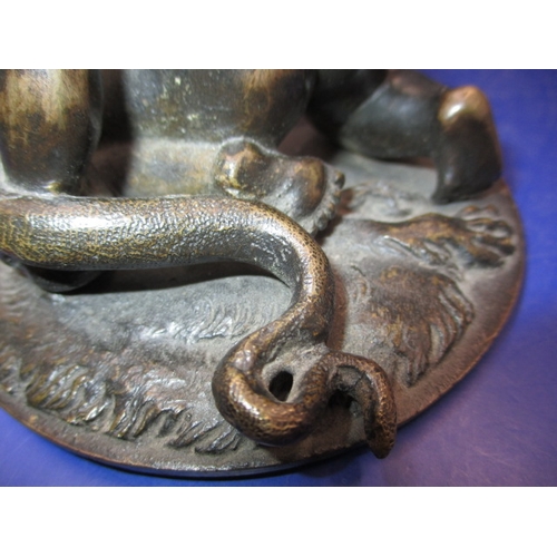 256 - An early 20th century two piece bronze sculpture of a man wrestling 2 snakes and sitting on a lion, ... 